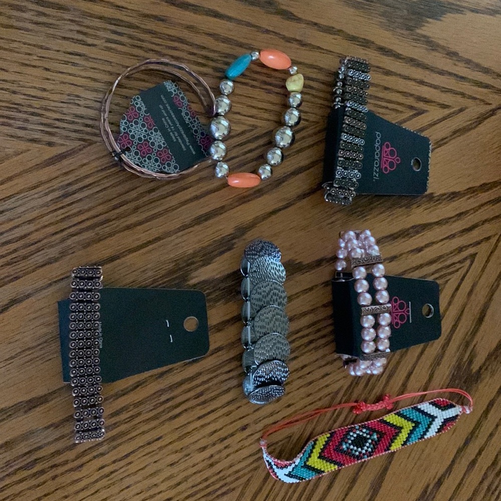 7 bracelets. 1 cuff, 1 pull cord. Rest are stretchy. Paparazzi $2.75 a piece.